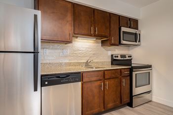 Modern kitchen with wooden cabinet and a marble counter top